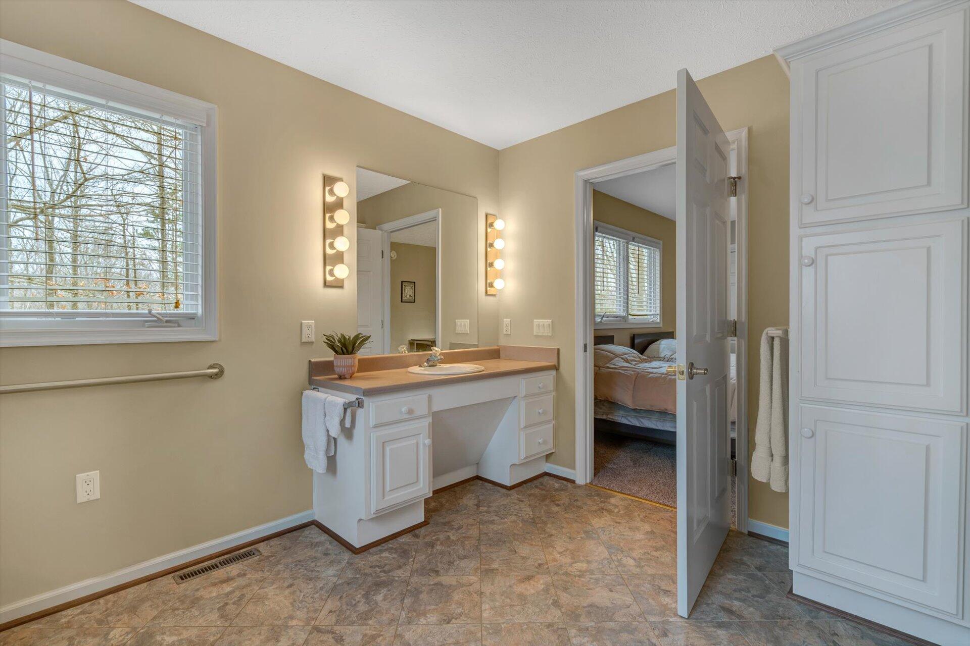 95 Echowood Lane Hardy, VA 24101 - Photo 19 of 46 a spacious bathroom with a double vanity sink a mirror and a bathtub