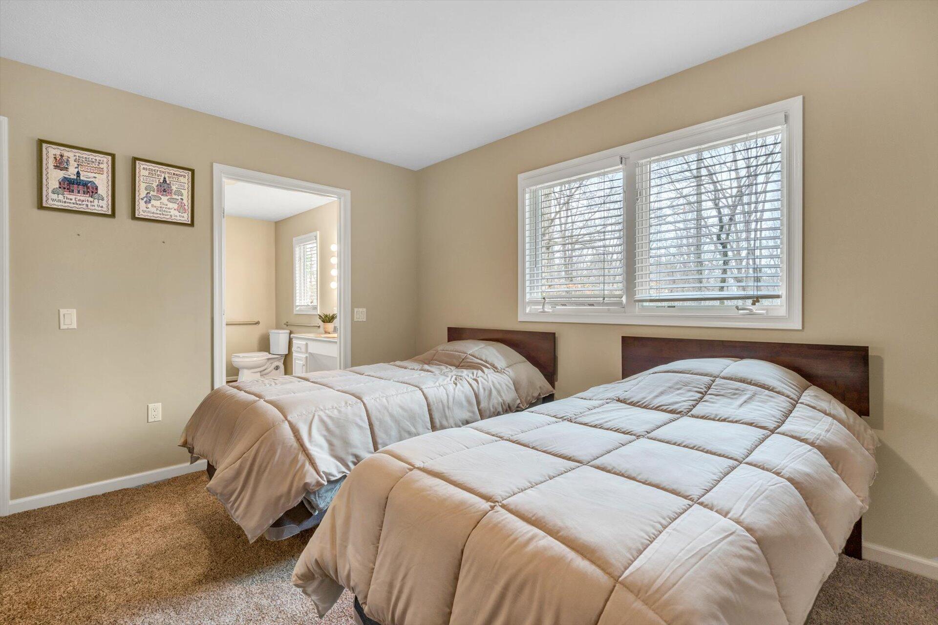 95 Echowood Lane Hardy, VA 24101 - Photo 22 of 46 a bedroom with two beds and a large mirror next to a window