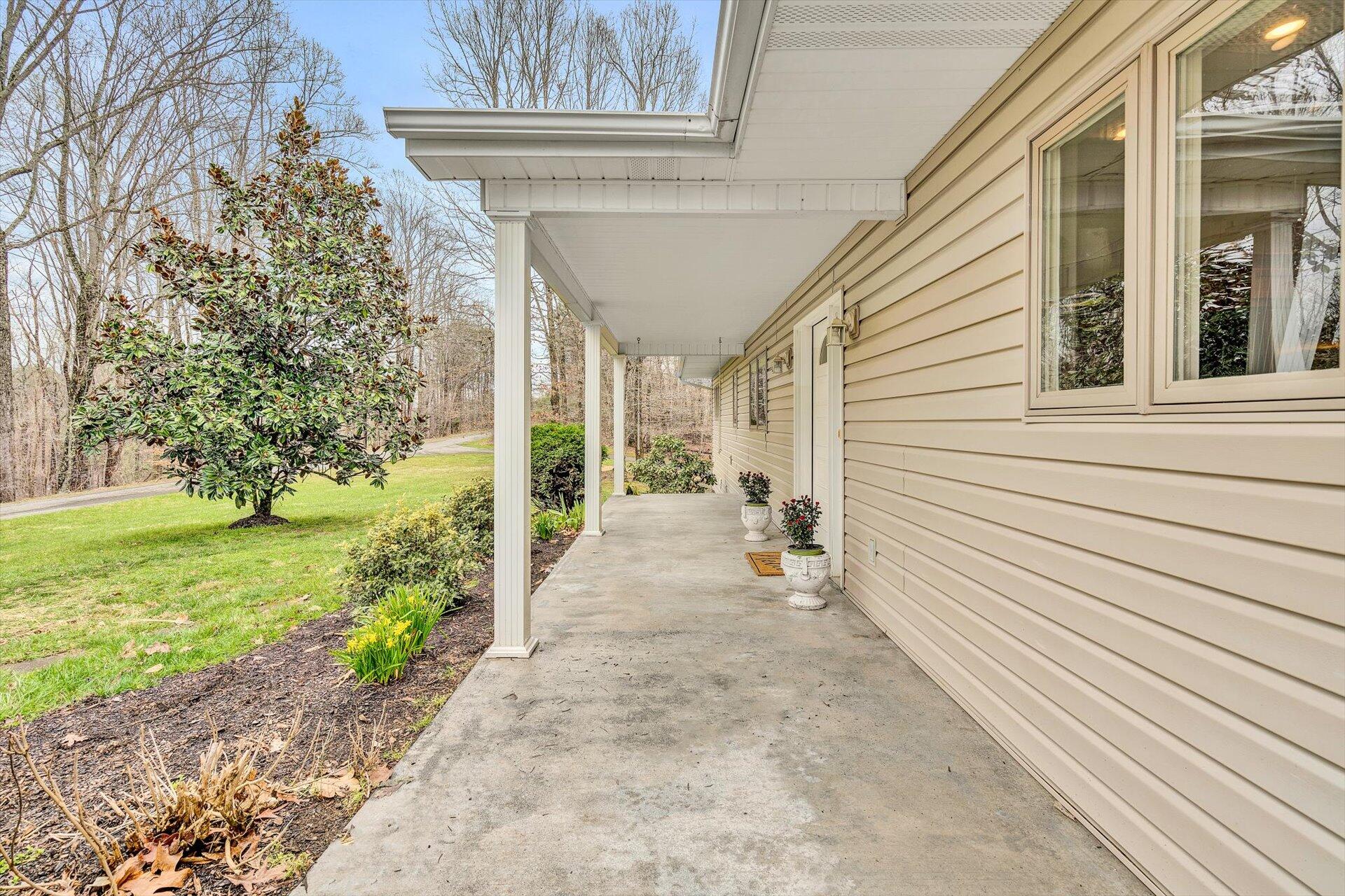 95 Echowood Lane Hardy, VA 24101 - Photo 5 of 46 a view of a patio with table and chairs and floor to ceiling window