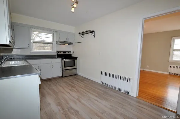 a kitchen with granite countertop a stove and a refrigerator