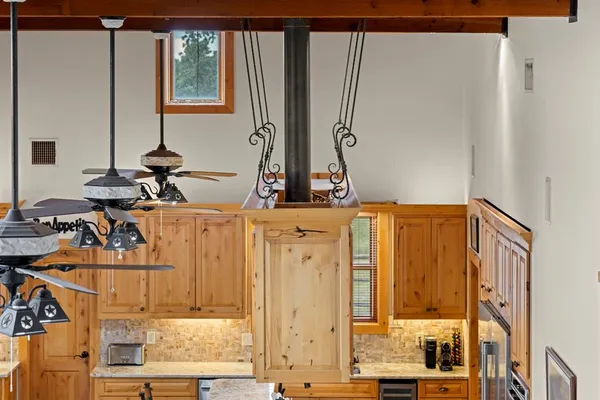 a kitchen with granite countertop a sink stainless steel appliances and cabinets