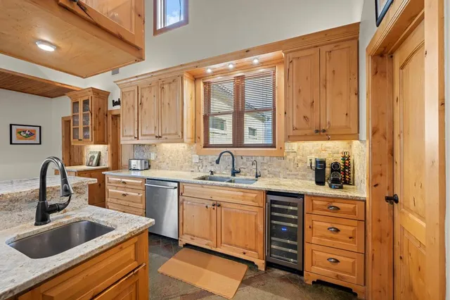 a dining room with furniture a kitchen view and chandelier