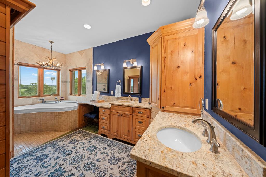 2320 Fiedler Road Harper, TX 78631 - Photo 20 of 62 a large bathroom with a granite countertop tub sink and mirror