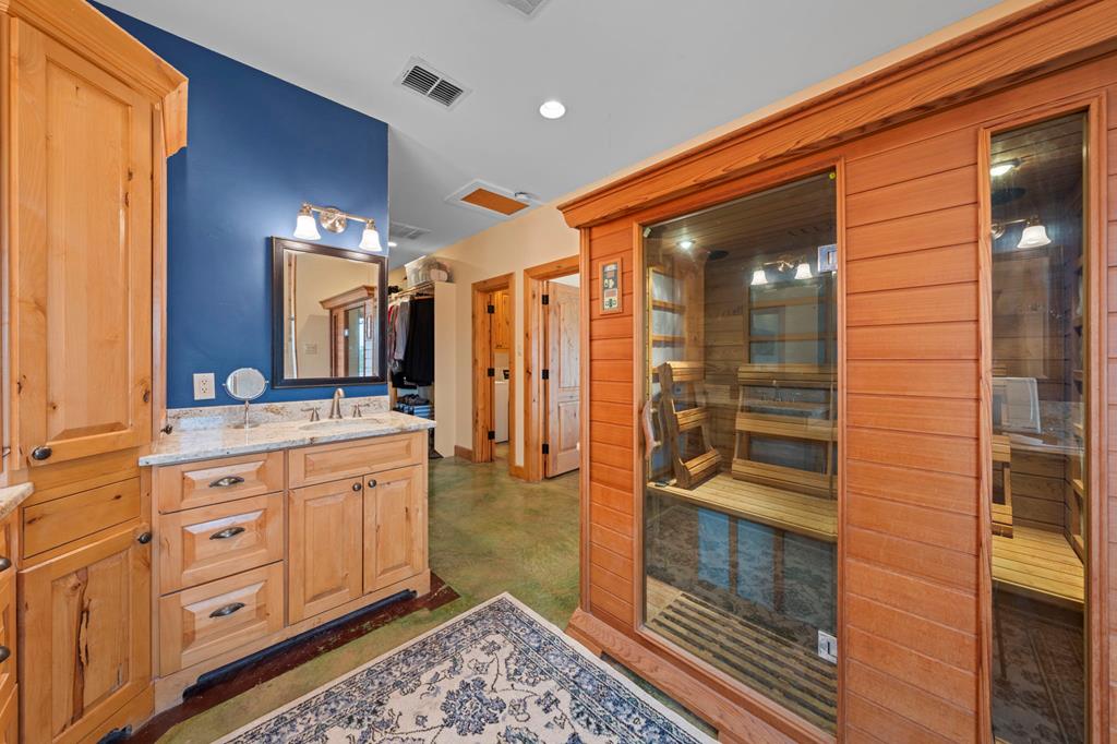 2320 Fiedler Road Harper, TX 78631 - Photo 21 of 62 a bathroom with a mirror and a shower