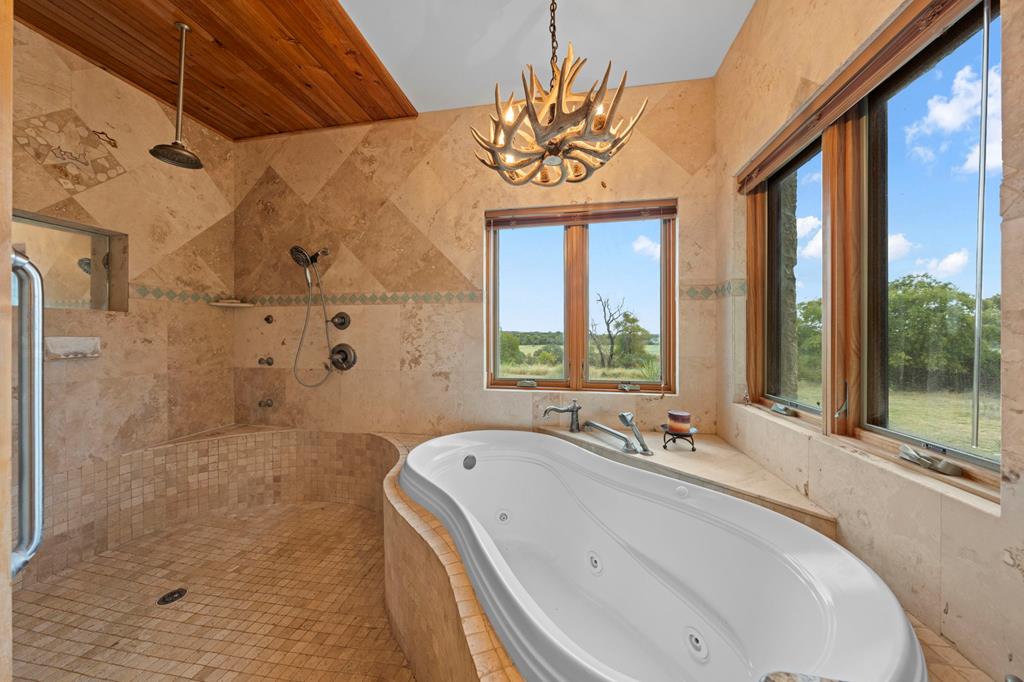 2320 Fiedler Road Harper, TX 78631 - Photo 22 of 62 a bathroom with a tub and a large window