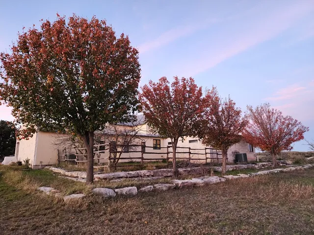 a view of house with backyard and outdoor seating
