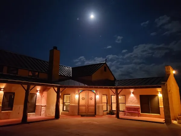 a view of a house with a yard and sitting area