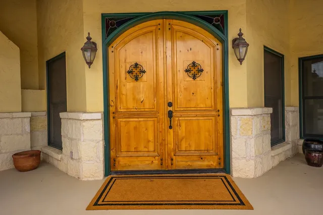 a view of a hallway with wooden floor and a bathroom