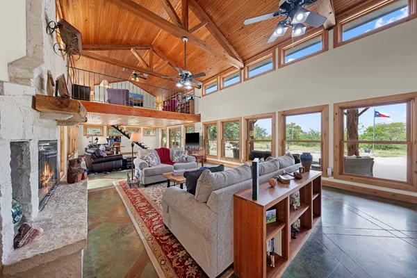 a living room with furniture fireplace and flat screen tv