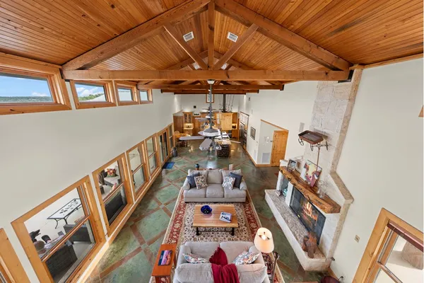 a kitchen with stainless steel appliances kitchen island granite countertop a table chairs and a refrigerator