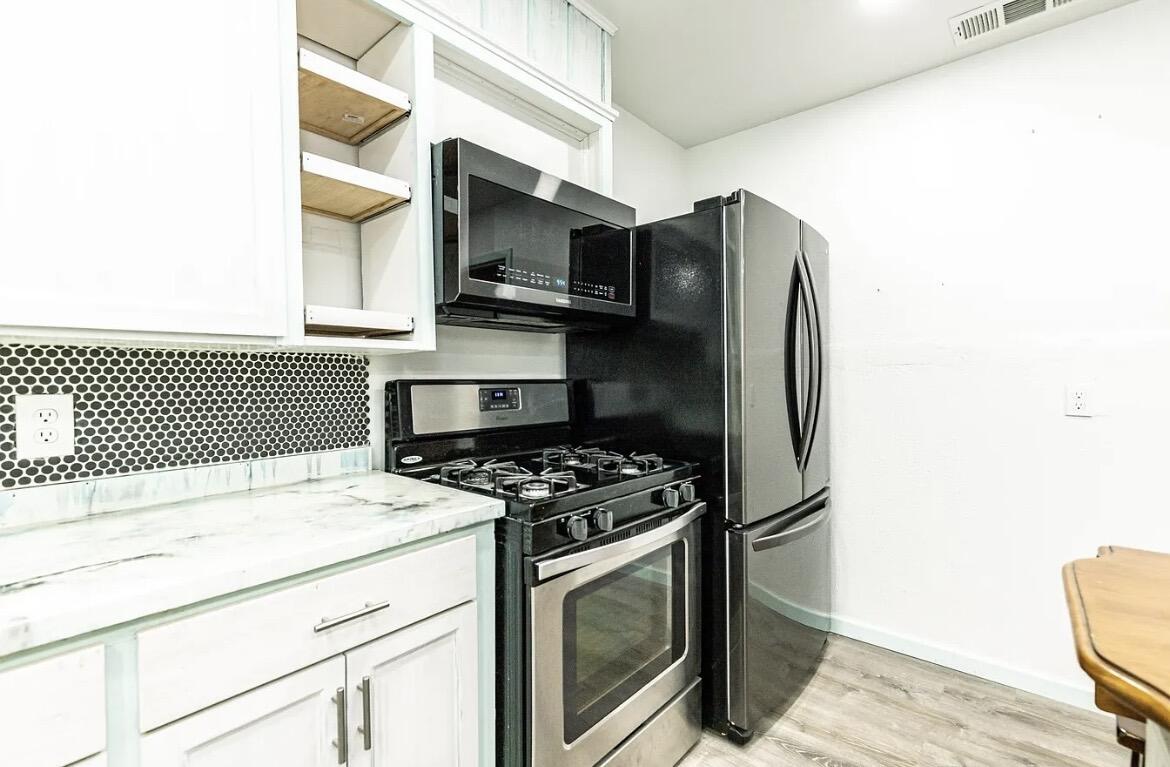 a kitchen with stainless steel appliances a stove and a refrigerator