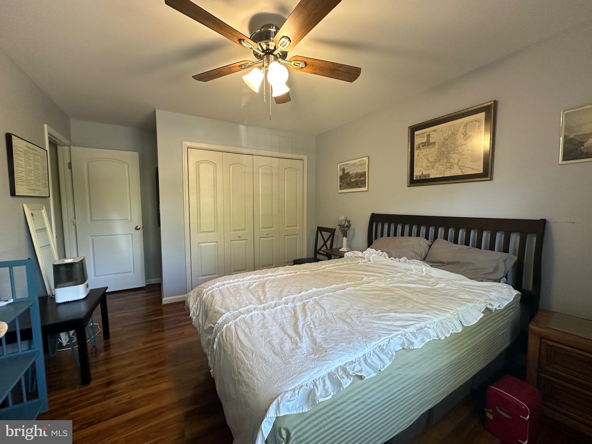 8244 Carrleigh Parkway Springfield, VA 22152 - Photo 18 of 25 a bedroom with a bed and a chandelier