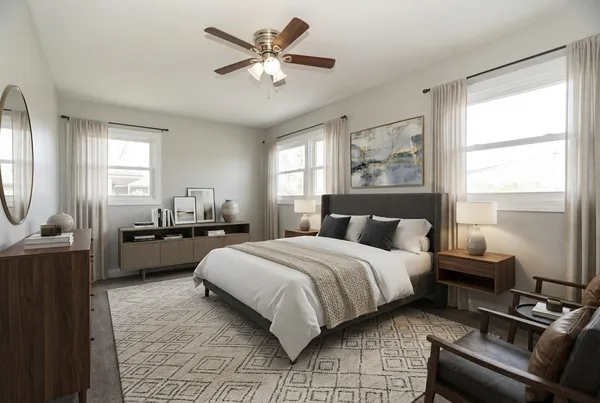 a bedroom with a bed a couch and dresser
