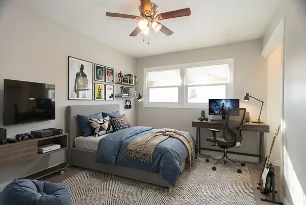 an empty room with a window and a fan