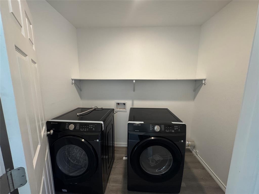 232 West Quanah Road Mabank, TX 75156 - Photo 7 of 13 Dedicated laundry area featuring a built-in white shelf for storage, white walls, and wood-finish flooring
