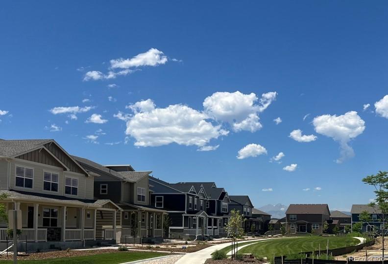 922 Logan Peak Way Berthoud, CO 80513 - Photo 7 of 9 a front view of a building with lot of cars and trees