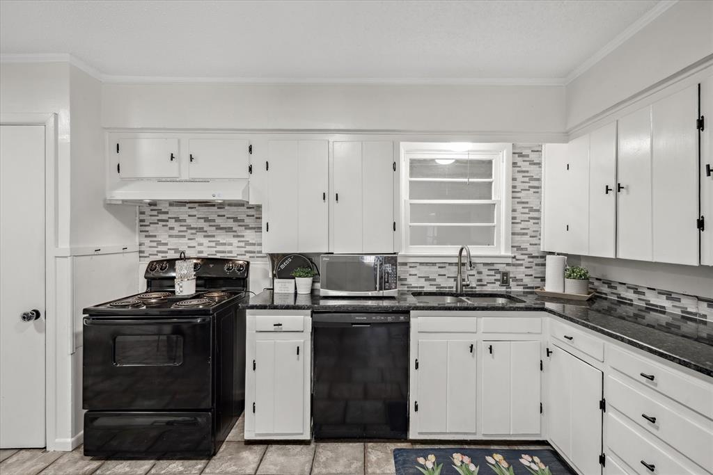 1460 Forrest Drive Canton, TX 75103 - Photo 12 of 36 a kitchen with granite countertop a stove sink and cabinets