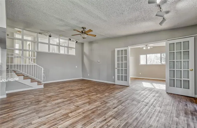 a kitchen with granite countertop white cabinets and wooden floor
