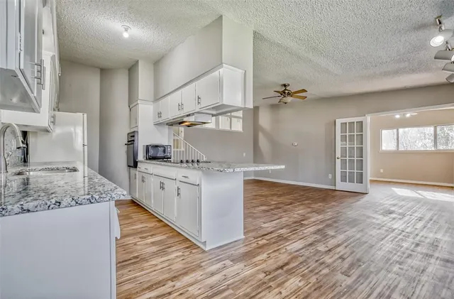 a kitchen with stainless steel appliances granite countertop a sink and cabinets