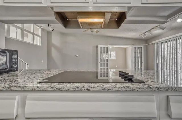 a view of room with window ceiling fan and wooden floor