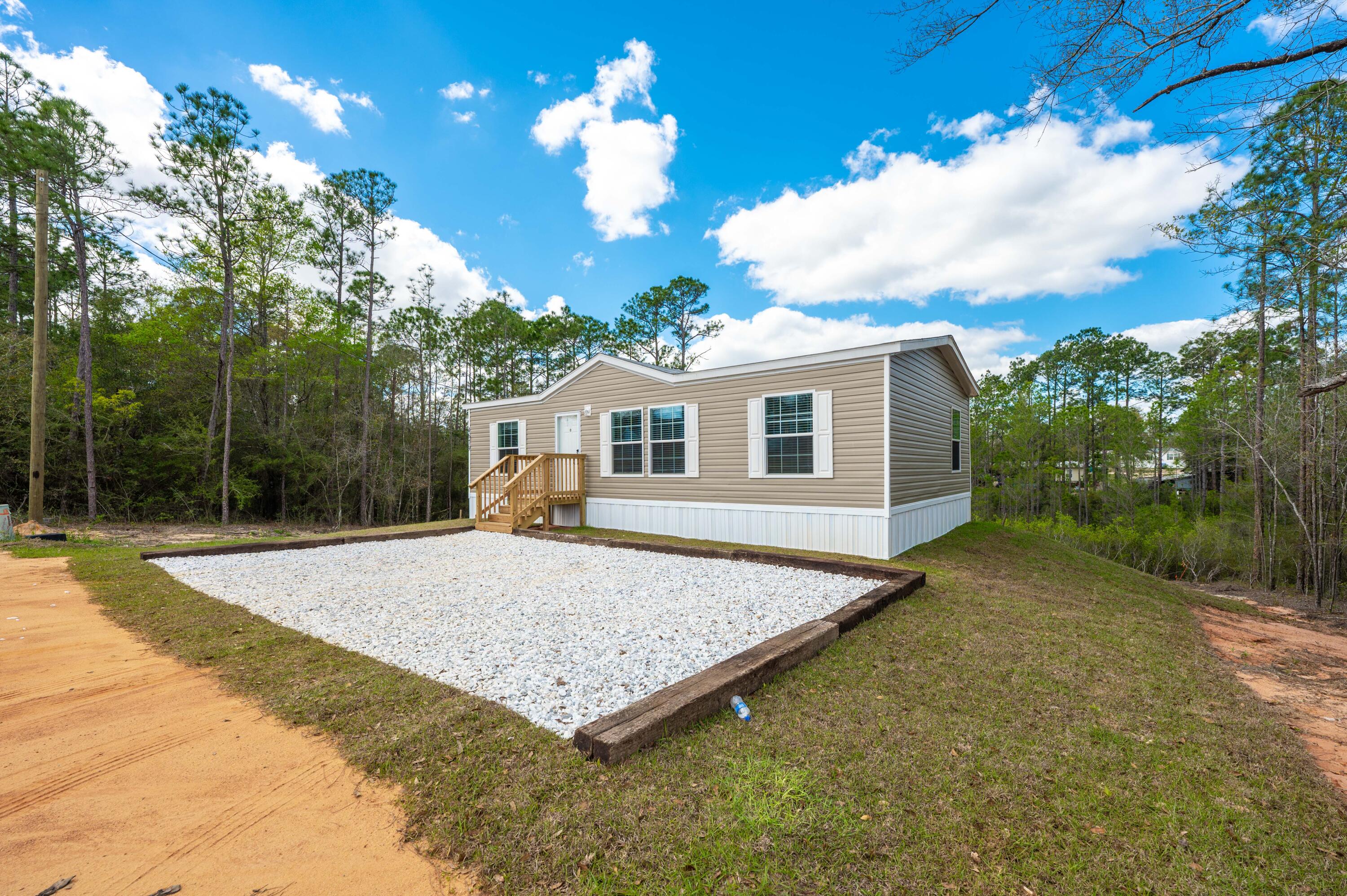 4679 Dove Way Crestview, FL 32539 - Photo 1 of 41 a view of a house with backyard and garden