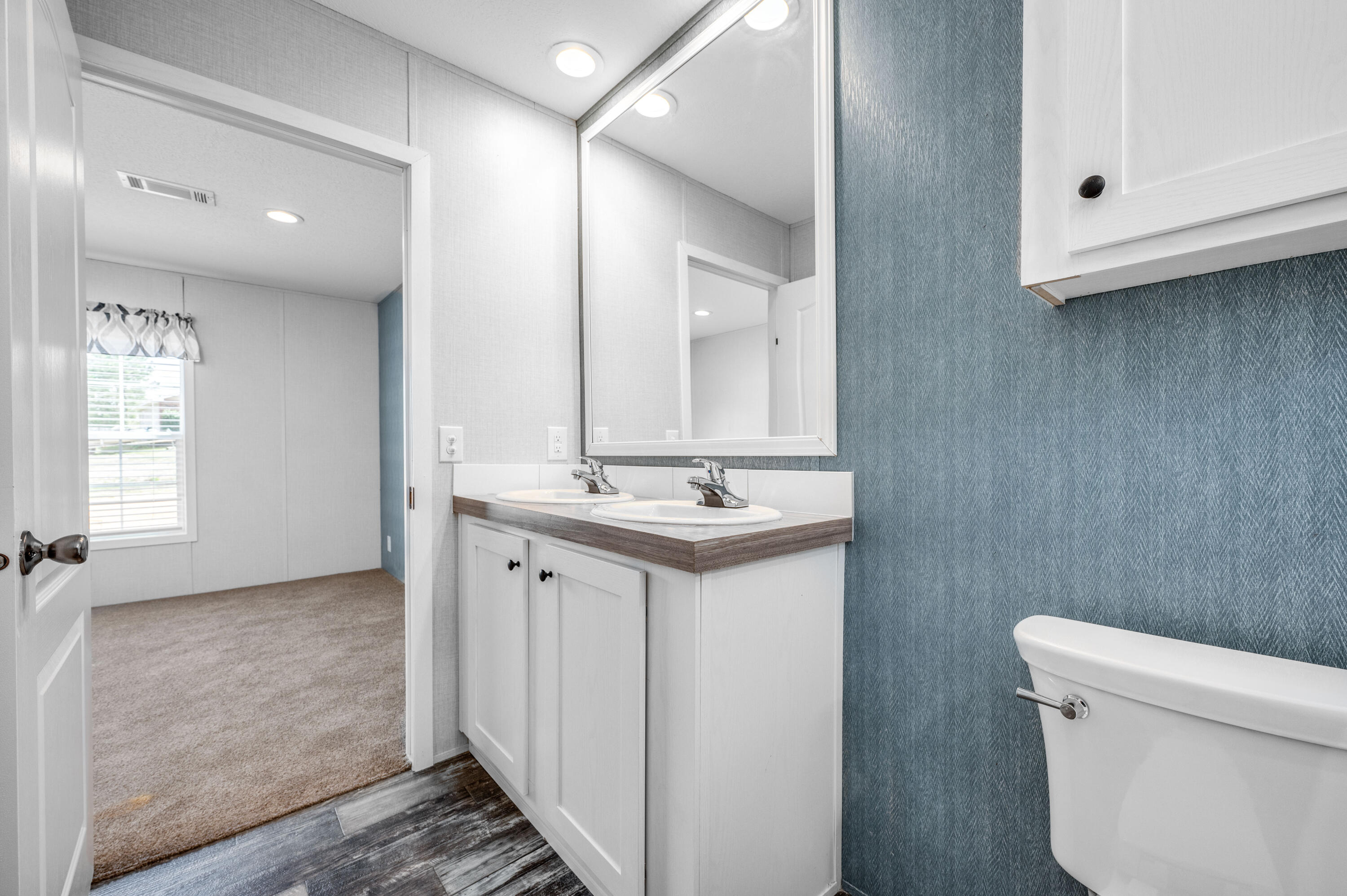 4679 Dove Way Crestview, FL 32539 - Photo 27 of 41 a bathroom with a sink a toilet and a mirror