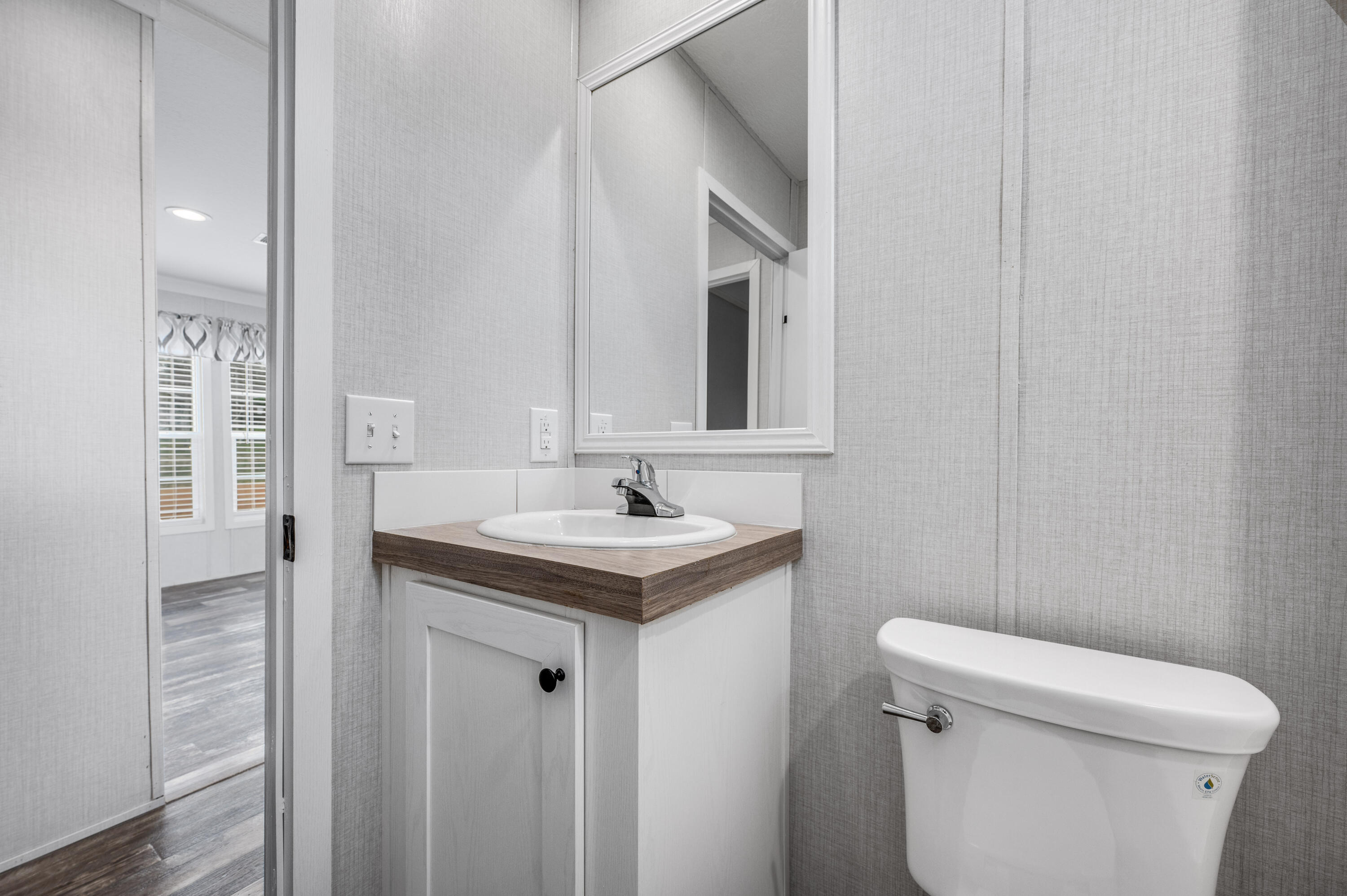 4679 Dove Way Crestview, FL 32539 - Photo 33 of 41 a bathroom with a sink a toilet and a mirror