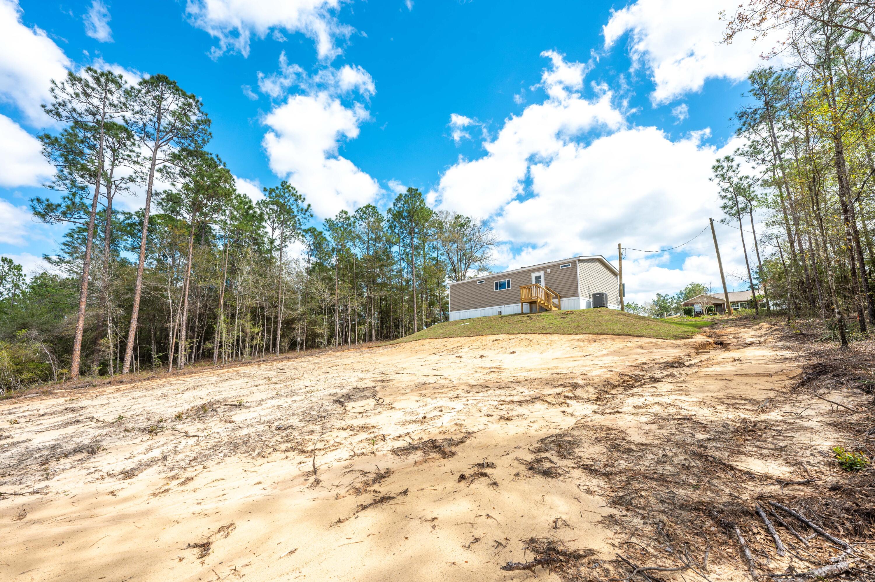 4679 Dove Way Crestview, FL 32539 - Photo 40 of 41 a house with trees in the background