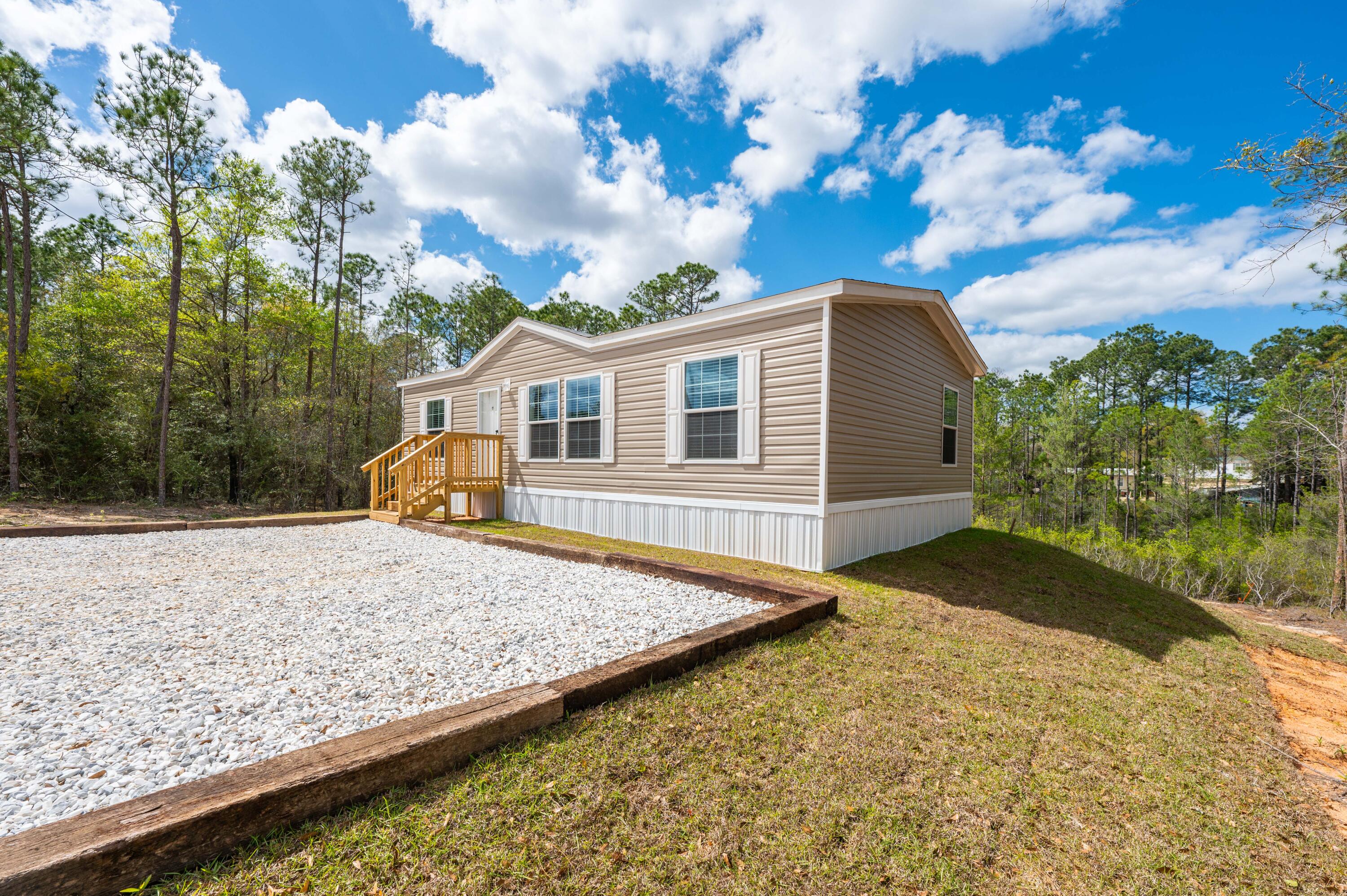 4679 Dove Way Crestview, FL 32539 - Photo 9 of 41 a view of a backyard with plants and lake view