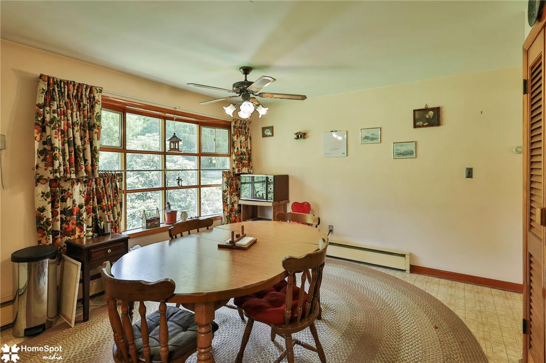 6054 Old Hickory Road Coopersburg, PA 18036 - Photo 15 of 48 Natural light pours through a large wood-framed window overlooking the verdant outdoors.