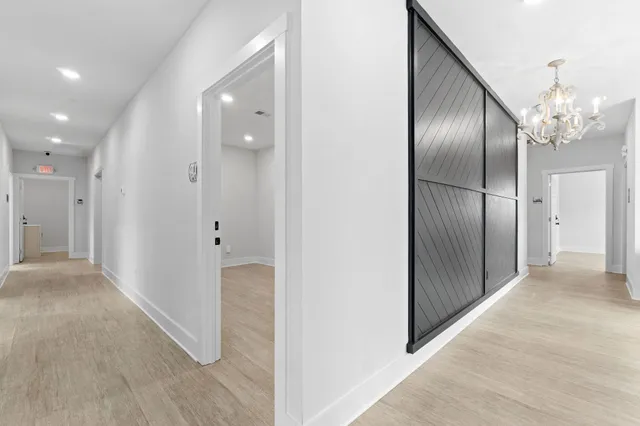a view of a hallway with wooden floor