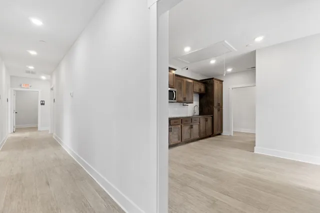 a view of a kitchen with a sink and a refrigerator