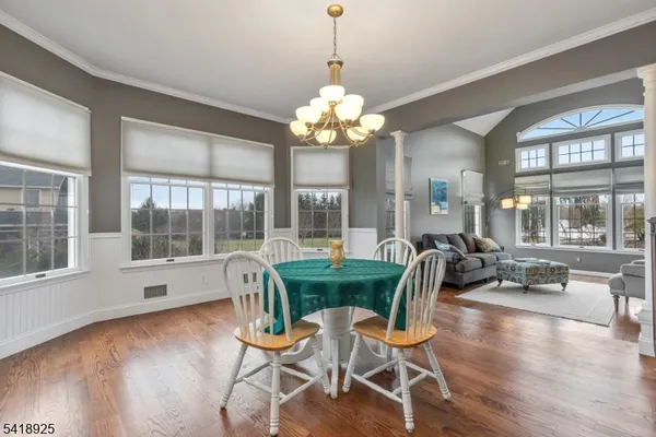 a view of a dining room with furniture and wooden floor