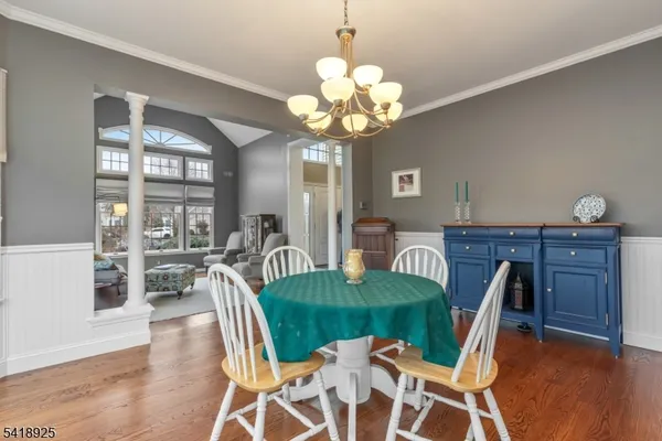 a kitchen with granite countertop a table chairs stove and cabinets