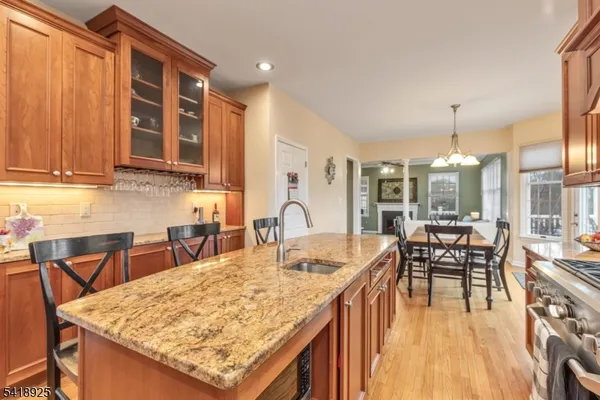 a kitchen with granite countertop kitchen island wooden cabinets a sink and a stove