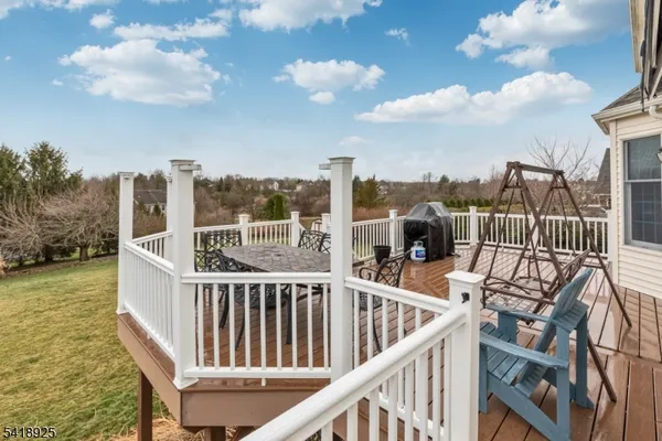 a view of a balcony with chairs and wooden floor