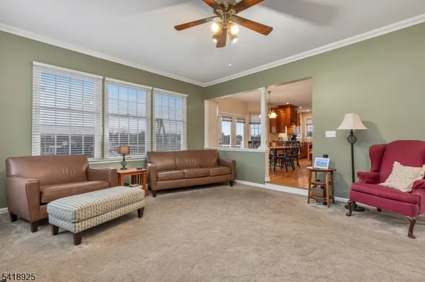 a view of a living room with furniture and wooden floor