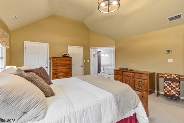 a spacious bedroom with a bed and window
