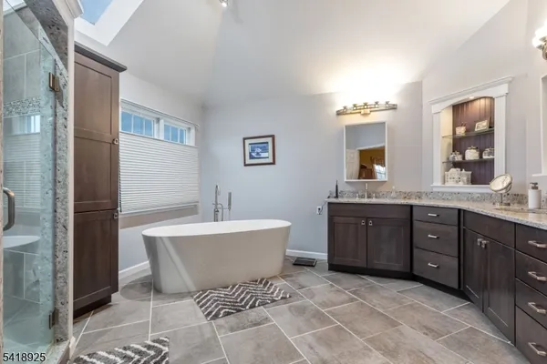 a bathroom with a bathtub and a shower