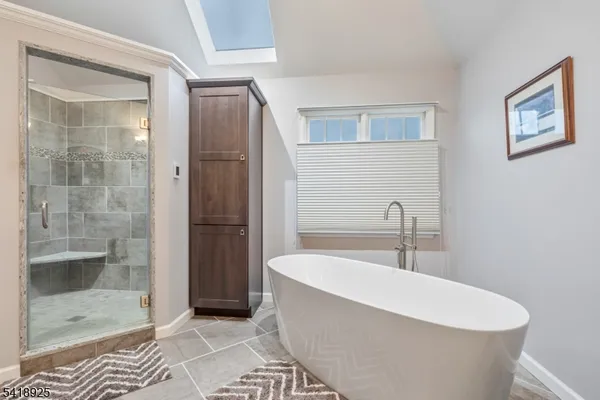 a bedroom with a bed next to a window