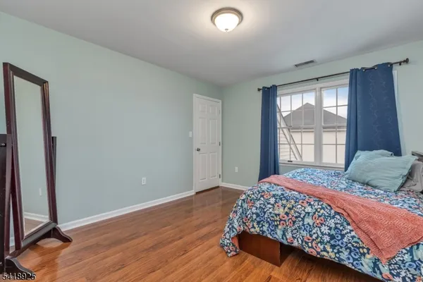 a view of a dining room with furniture and a book shelf