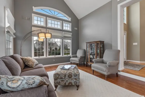 a bathroom with a granite countertop toilet sink and mirror