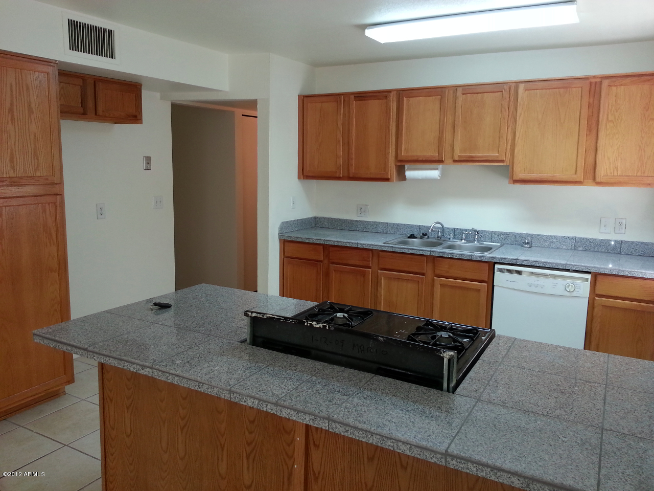 3043 West Bloomfield Road Phoenix, AZ 85029 - Photo 13 of 18 a kitchen with granite countertop a sink a stove and cabinets