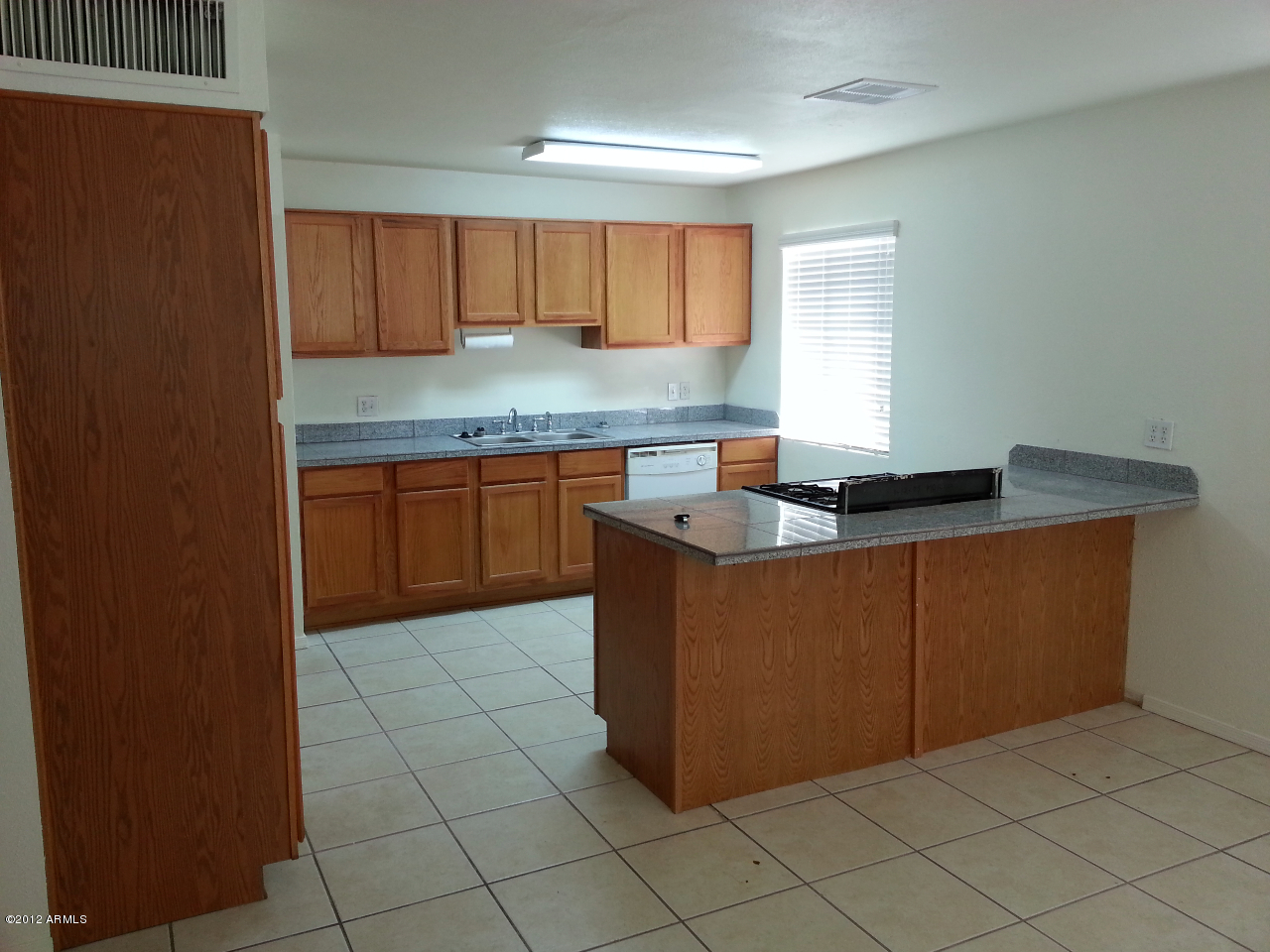 3043 West Bloomfield Road Phoenix, AZ 85029 - Photo 14 of 18 a kitchen with granite countertop sink and cabinets