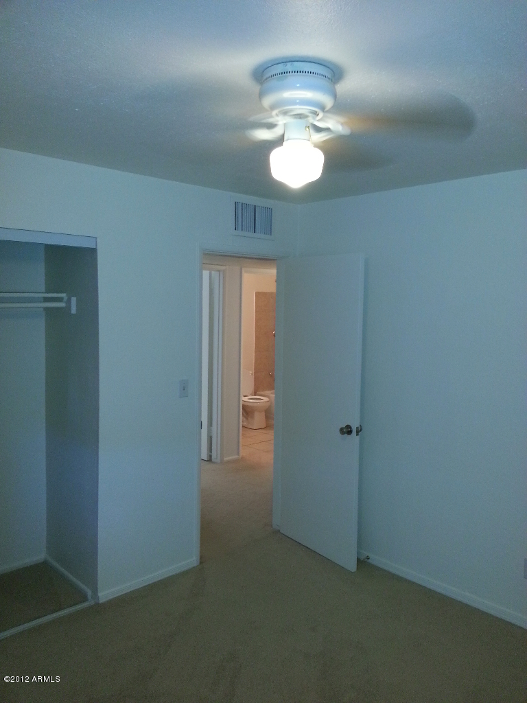 3043 West Bloomfield Road Phoenix, AZ 85029 - Photo 17 of 18 an empty room with chandelier fan