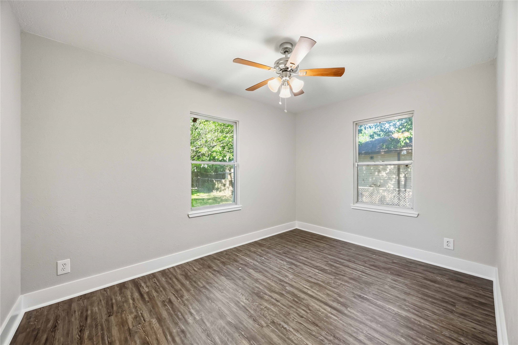 113 East Witcher Lane Houston, TX 77076 - Photo 19 of 21 a view of an empty room with wooden floor and a window
