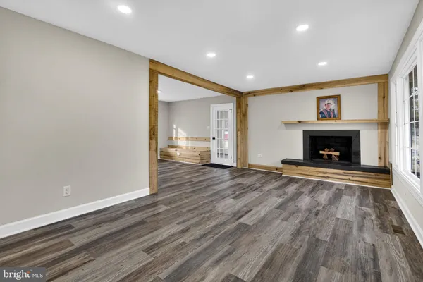 a view of empty room with wooden floor and ceiling fan