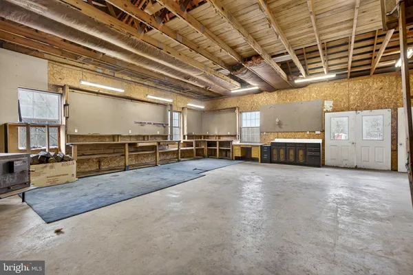 a view of a house with a big yard and large trees
