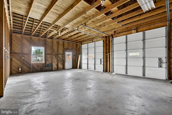 a living room with a fireplace and a painting on the wall
