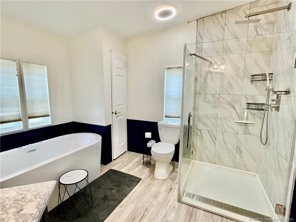 16398 Southwest Two Wood Way Indiantown, FL 34956 - Photo 13 of 24 a bathroom with a sink a toilet and shower